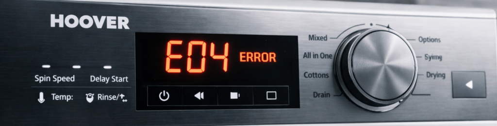 Close‑up of a Hoover washing machine control panel showing the E04 error code on its digital display in a modern laundry room.